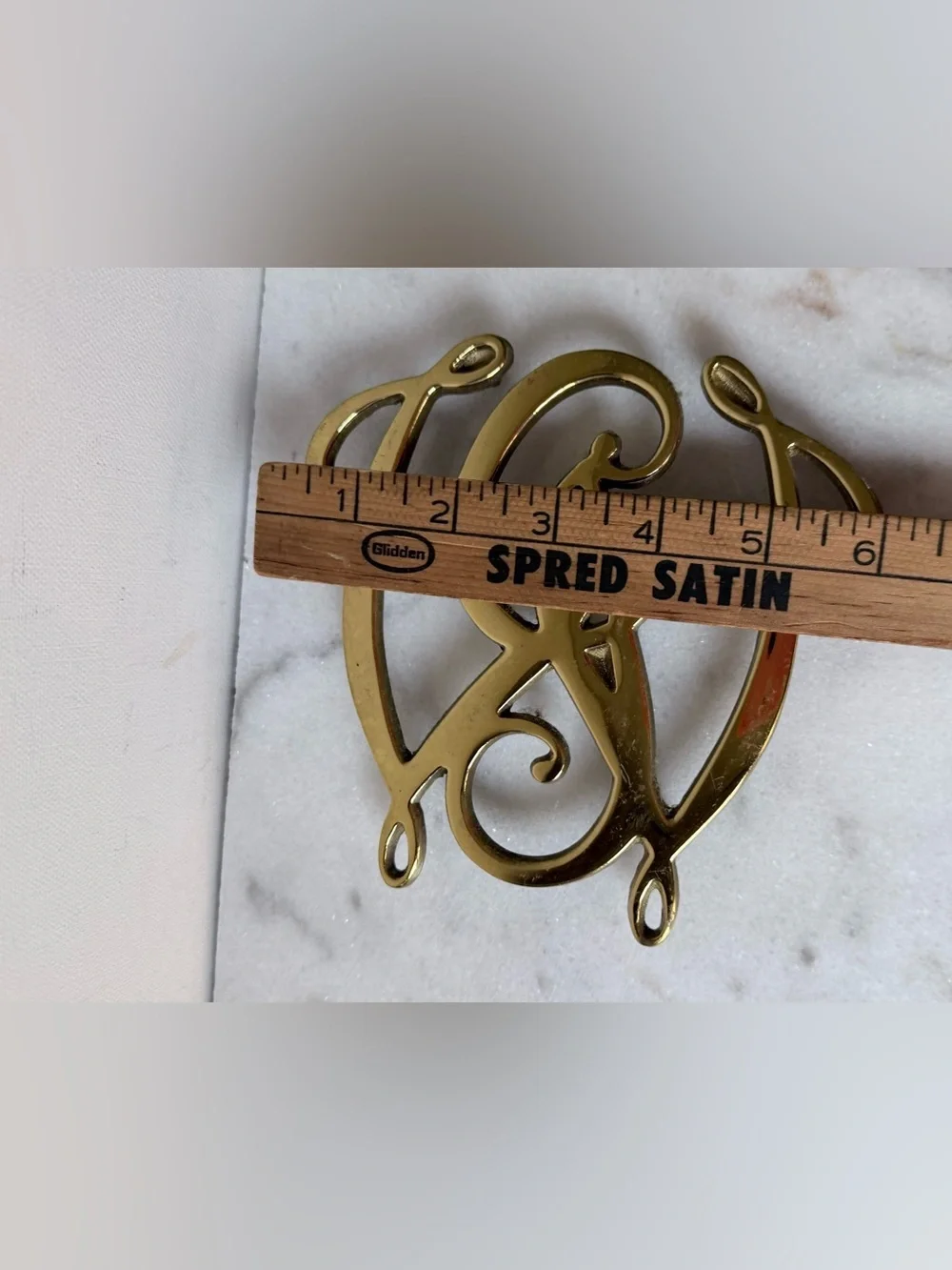 George Washington Cypher solid brass trivet, likely by Virginia Metalcrafters.